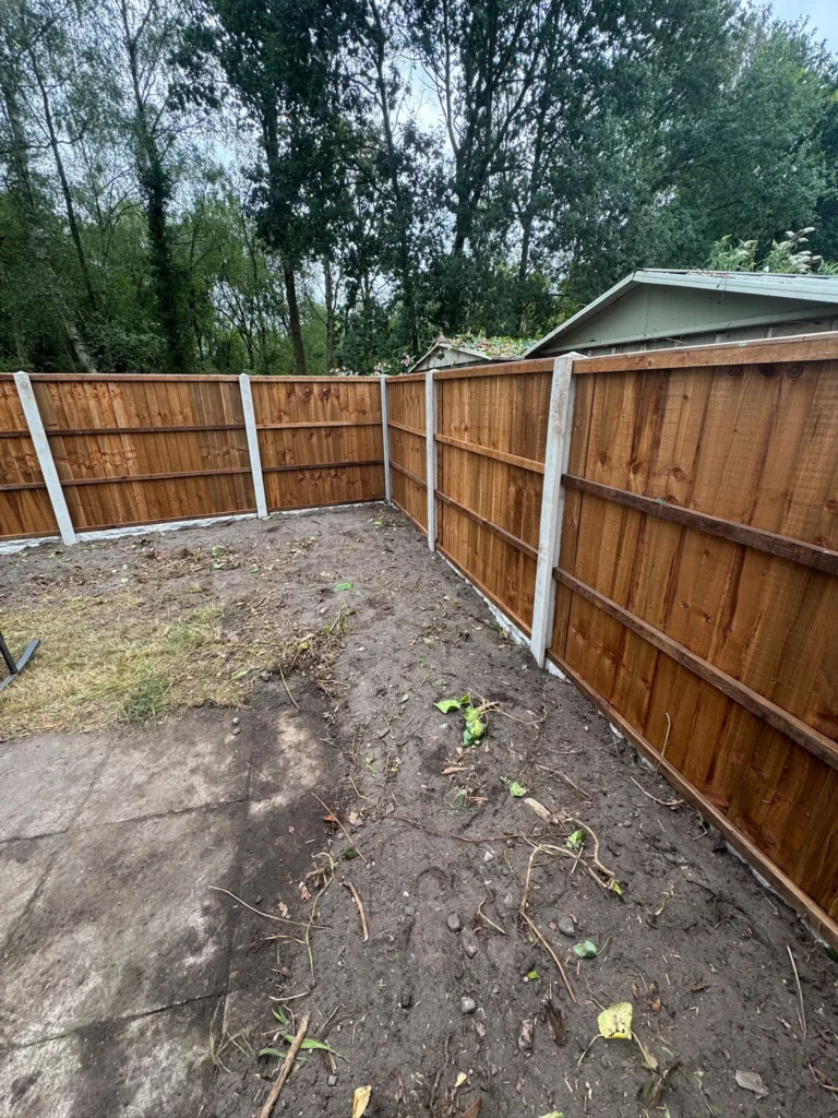 A completed closeboard fence line enclosing a rear garden ready for landscaping